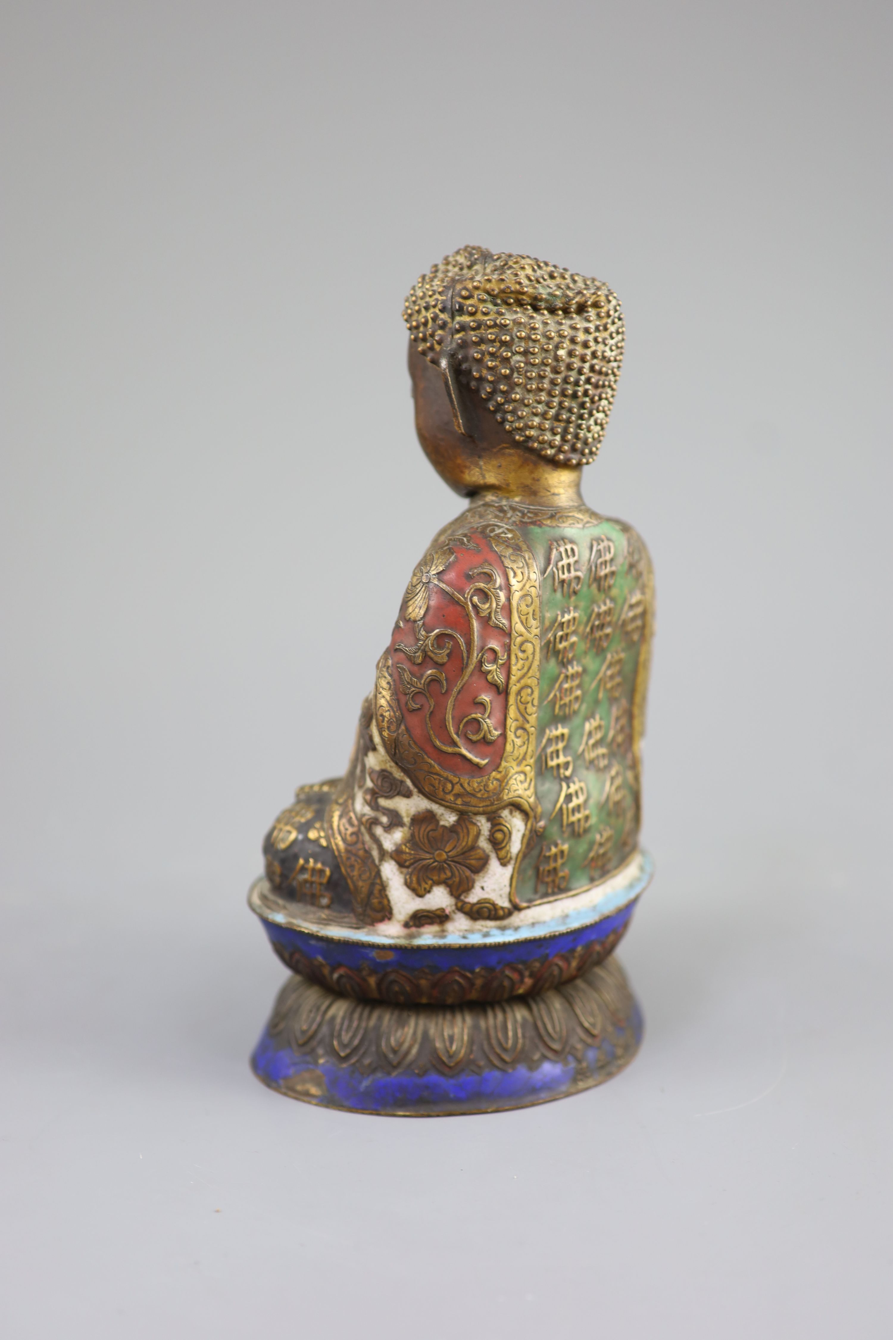 A Chinese copper alloy and enamel seated figure of Buddha Shakyamuni, Qing dynasty, 24cm high, faults